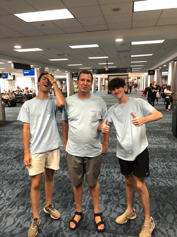 Ryan, Shannon, and Brendan at the airport terminal thumbs up