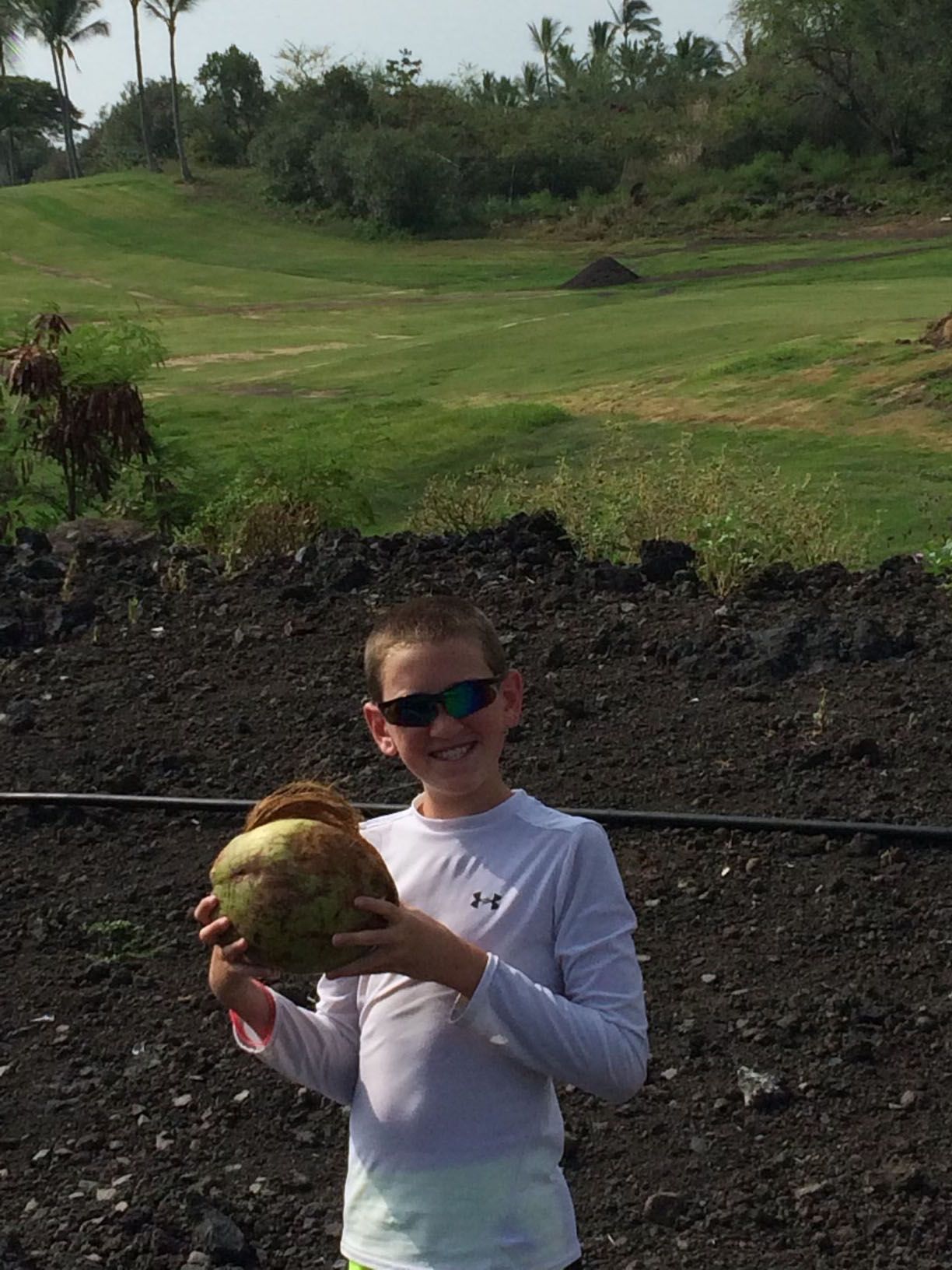 ryan with a coconut in field